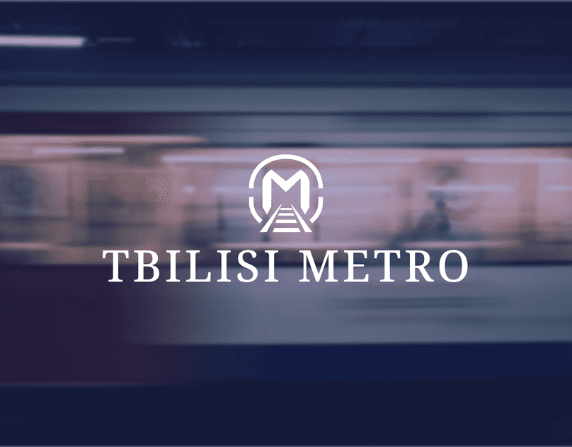 White Tbilisi Metro identity over a blurred train photograph