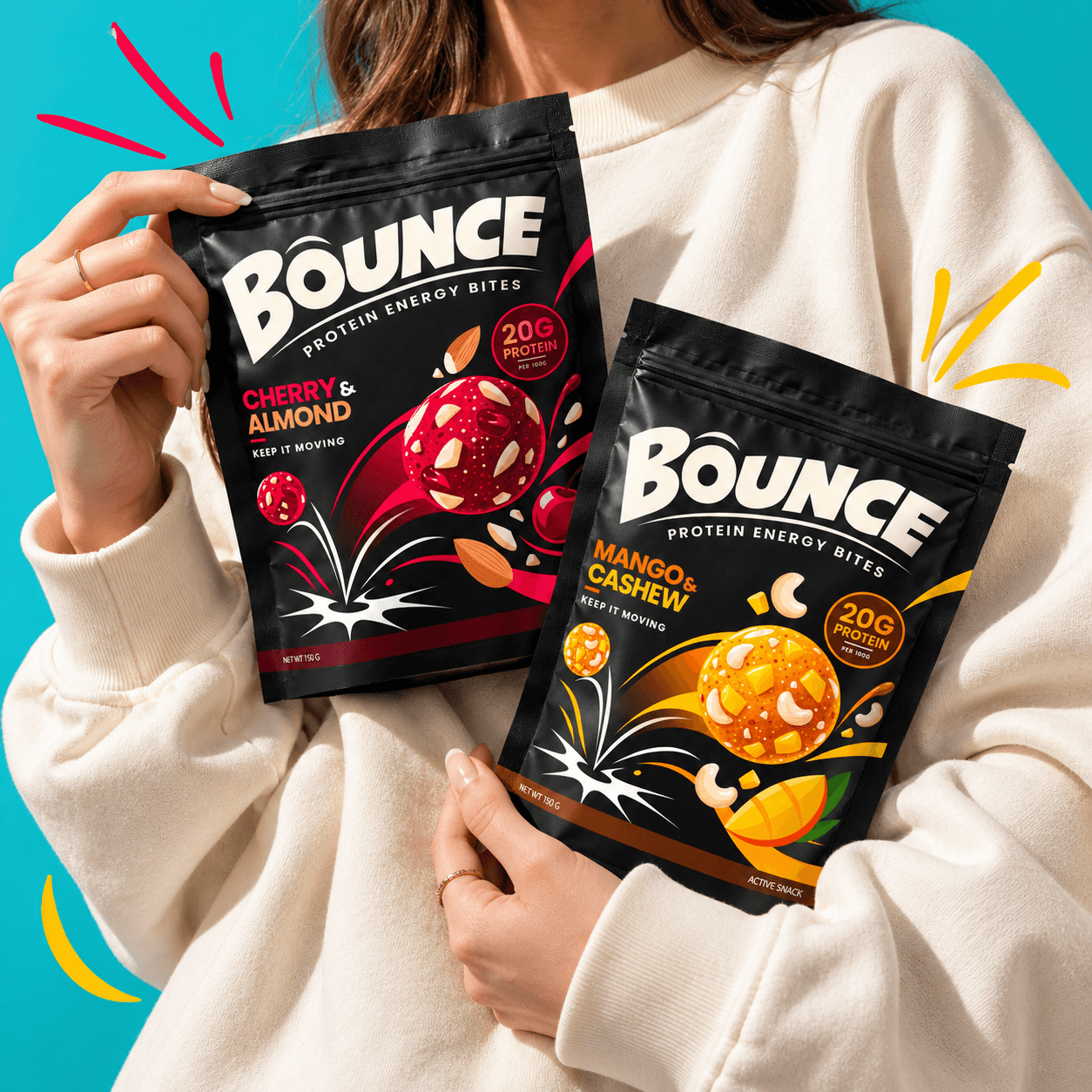 Bounce cherry and almond and mango and cashew protein snack packs against a turquoise background